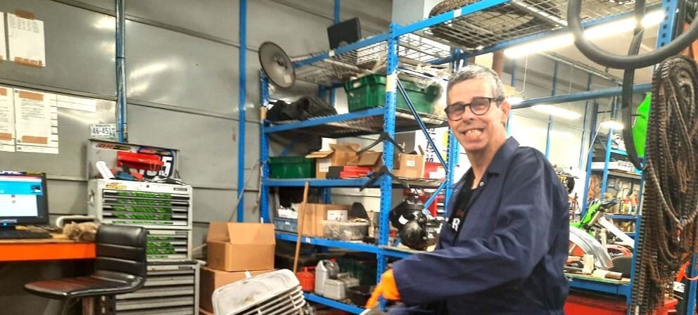 Darren, a man with learning diabilities supported by ambient, is volunteering at his local mechanic garage